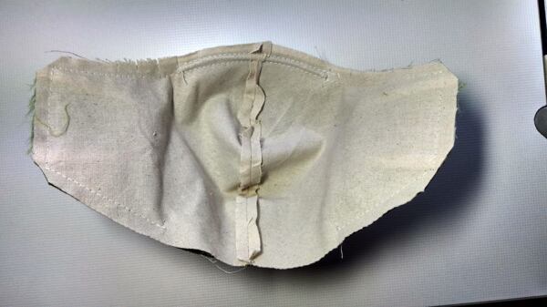 jak ušít roušku – ustřihněte rohy švových přídavků a nastřihněte několikrát v zakřivené části kolem nosu